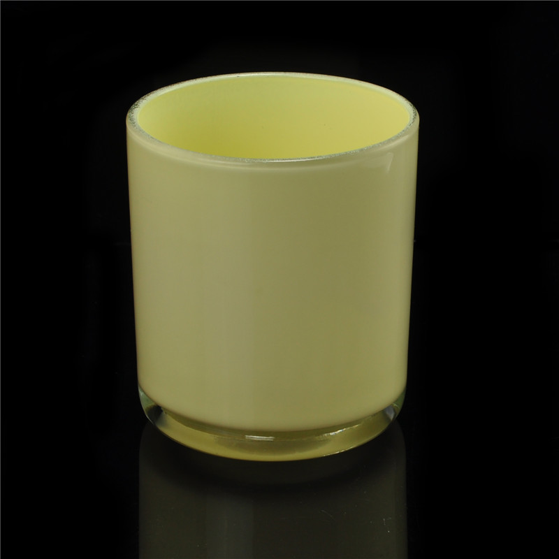 Yellow painted cylindrical glass vessel for candles