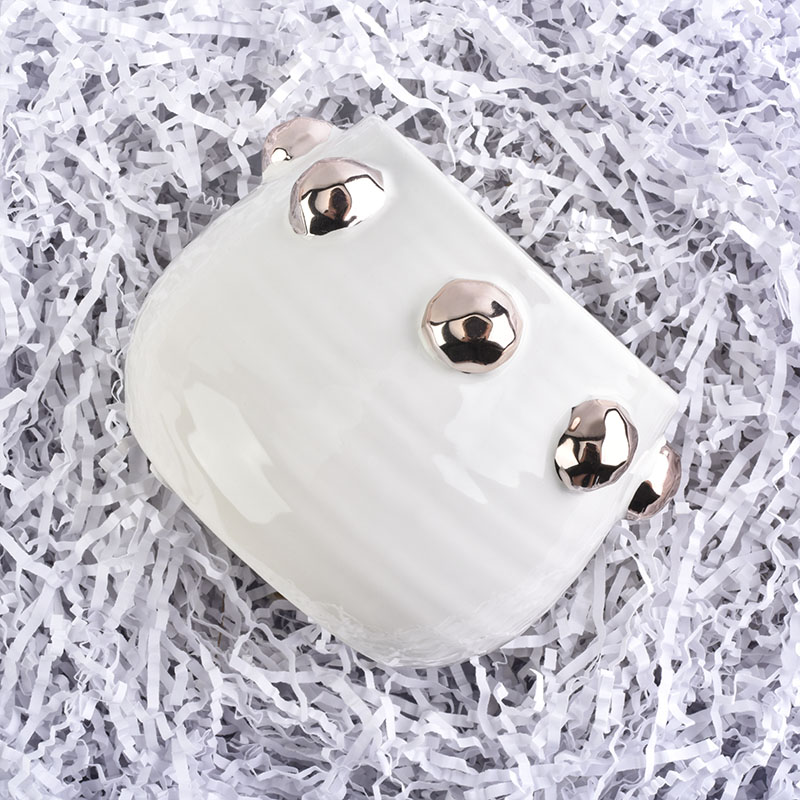 white ceramic candle jar with shiny golden dots