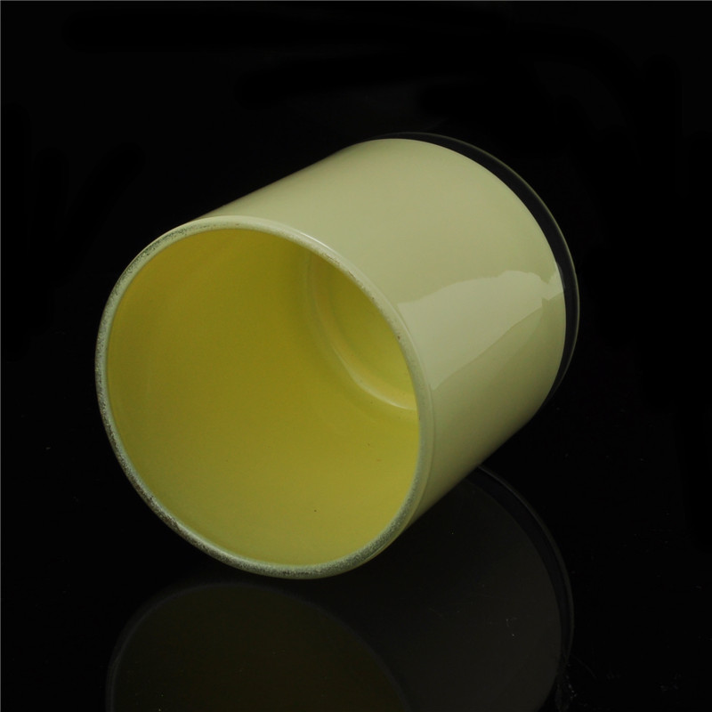 Yellow painted cylindrical glass vessel for candles