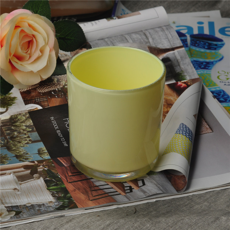 Yellow painted cylindrical glass vessel for candles