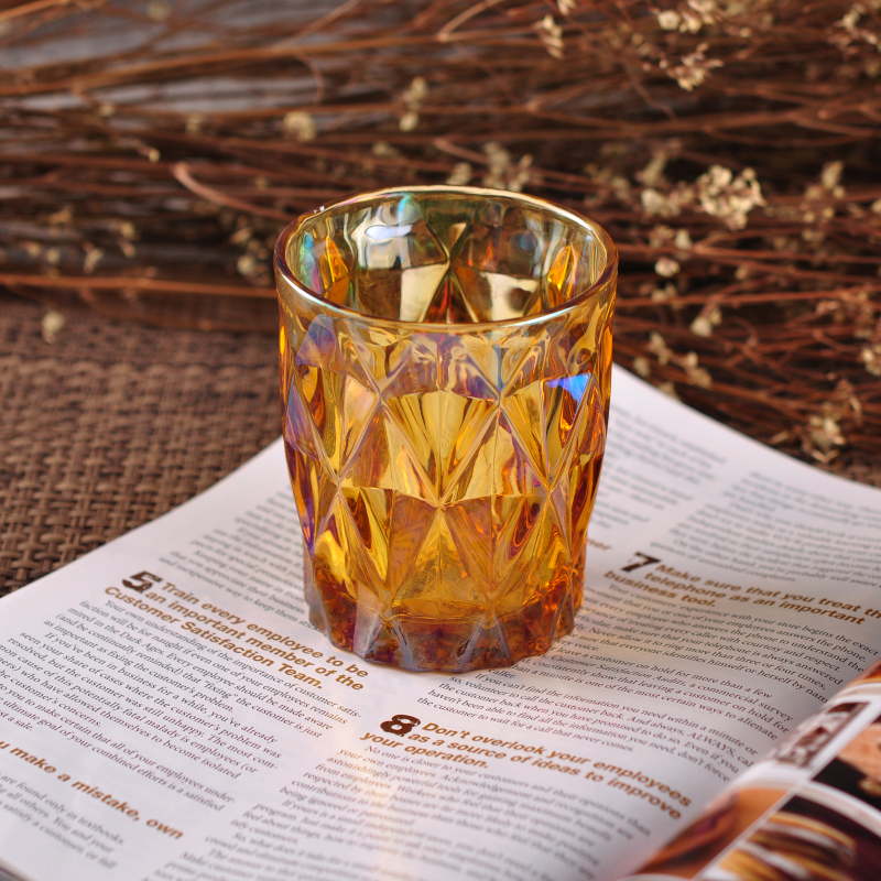 Iridescent glass candle holder with diamond-shaped pattern surface