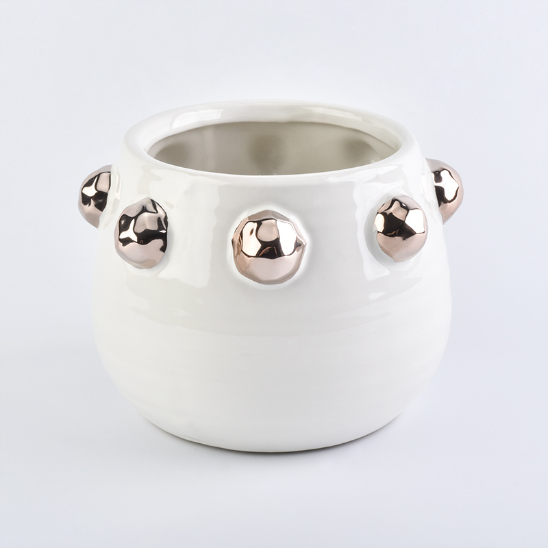 white ceramic candle jar with shiny golden dots