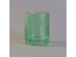 Green round straight-sided glass candle holder with rain drops effect