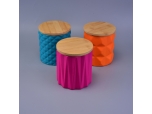 bright-colored ceramic jars for candles with wood lid