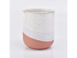 orange white ceramic candle jar with dots