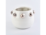 white ceramic candle jar with shiny golden dots